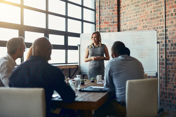 Giving them freedom to express themselves. Cropped shot of a young pregnant businesswoman giving a presentation in the boardroom.