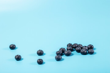 Blueberries close up on blue background.