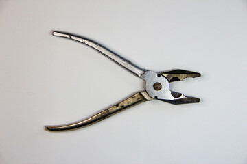 Open chrome pliers on white background