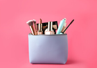 Cosmetic bag with makeup products and accessories on pink background - obrazy, fototapety, plakaty