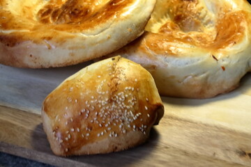 An asian samsa with beef filling and a couple of loaves of asian bred 