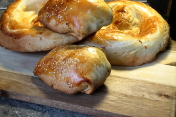 Two samsas and two loaves of plate asian bread