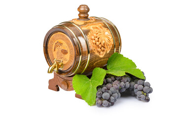 one wooden wine storage barrel with a freshly cut bunch of grapes lying next to it on a white isolated background