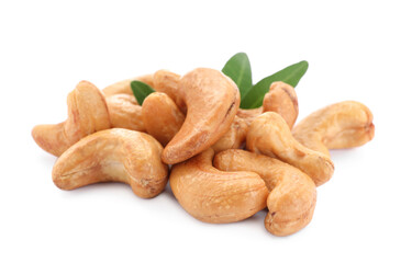 Pile of tasty organic cashew nuts and green leaves isolated on white