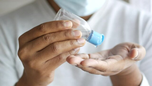 men with face mask Using sanitizer liquid for preventing corona virus