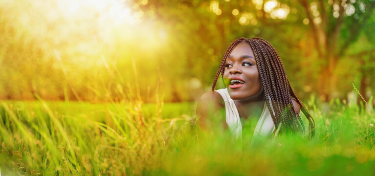 Pretty smiling African girl relaxing outdoor