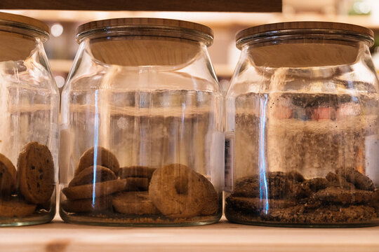 Jars with cookies placed on shelf