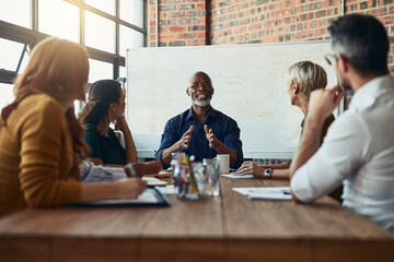 Dictating the direction of the meeting. Cropped shot of a mature businessman leading a meeting in...
