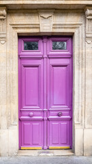 Paris, an ancient wooden door, colorful facade in the 11e arrondissement
