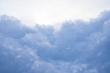 Fluffy snow against the sky, on a winter evening, at sunset. Copy space. Abstract background. Bottom view.