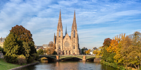Fototapeta na wymiar Saint-Paul church at Ill river water panorama Alsace in Strasbourg France
