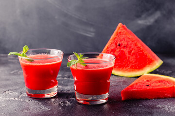 Fresh tasty delicious watermelon juice on a dark background