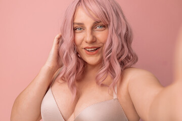 Close up portrait of happy beautiful wo man working on online flirting webcam model isolated pink background with copyspace