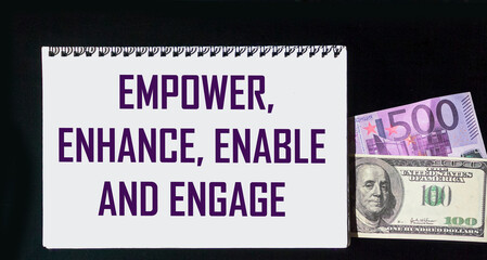 motivational leadership, coaching or business concept - empowerment, improvement, inclusion and engagement words on notepad with dollar and euro bills