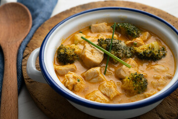 Chicken cooked in curry with broccoli and coconut milk.