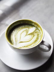 hot green tea and smartphone next to windown relaxing and rest time