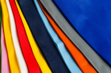 colorful non-woven fabric tote bag texture. pile of textured and porous polypropylene material....