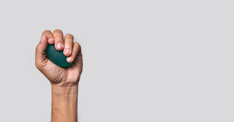  Asian man hand gripping hand exercise elastic ball.
