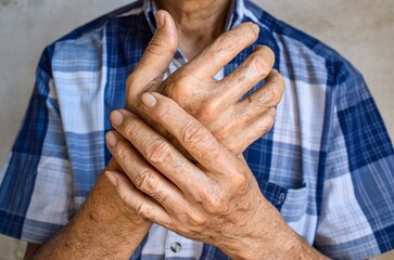 Fingers and hands of Asian elder man. Concept of hand pain, rheumatoid arthritis and finger problems.