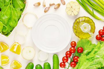 Organic farm vegetables and empty white plate on a white background. The concept of vegan healthy...