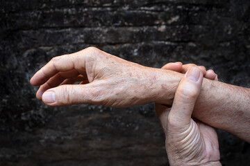 Hand of Asian elder man. Concept of joint pain, arthritis or hand problems.