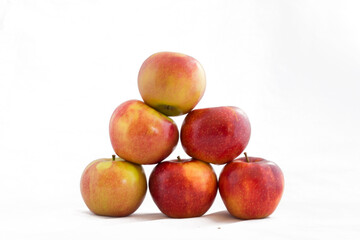 Fototapeta na wymiar A pyramid of apples isolated on a white background