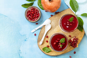 Winter panna cotta with pomegranate jelly and mint, italian dessert, homemade cuisine. Top view...