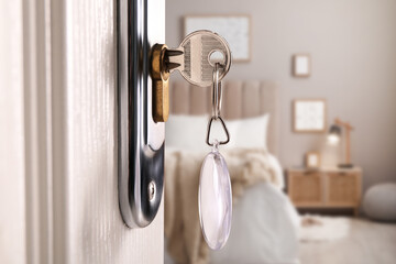 Closeup view of door with key open in bedroom