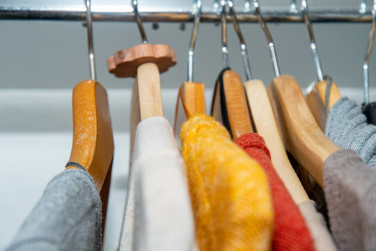 Colourful clothes in the wardrobe with moth protection made of Swiss pine