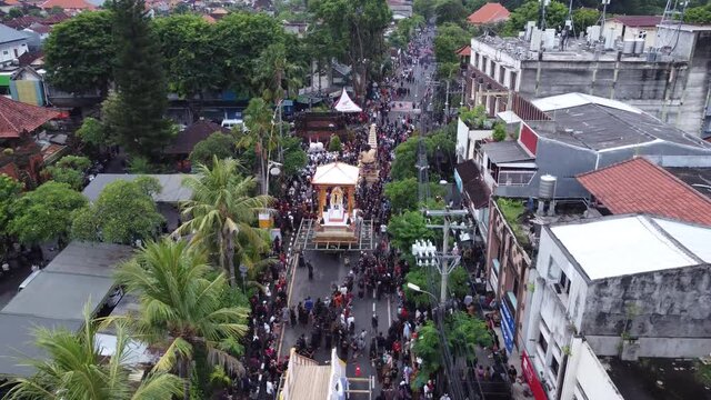 Denpasar, Bali, Indonesia - JANUARY 11 2022: Royal Cremation Ceremony Parade The King of Denpasar Ida Cokorda Pemecutan XI - Aerial Drone View
