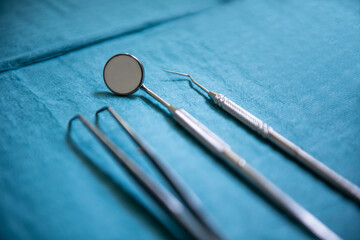 Close-up shot of dental instruments used for examining the teeth, a dental scaler, mouth mirror,...