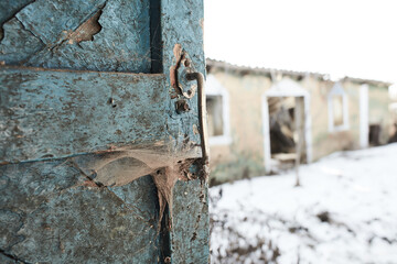 Old door handle with cobweb in old abandoned yard