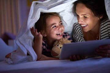 Can we read another one, Mom. Cropped shot of an attractive young woman reading her daughter a...