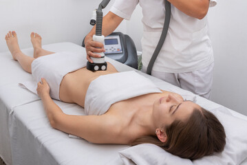 young woman in an aesthetic center performing a treatment for the beauty of the skin and body with the method of velaslim plus applied by an aesthetic professional