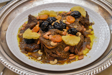 Meat dish with plum, dried pineapple and almonds. One of the most famous Moroccan dishes