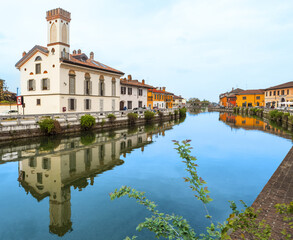 Colourful houses reflected in the Naviglio Grande waterway in Gaggiano, an agricultural village on the outskirts of Milan,Italy.