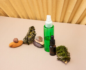 a bottle of facial skin care oil stands on a combined paper background, a cosmetic concept