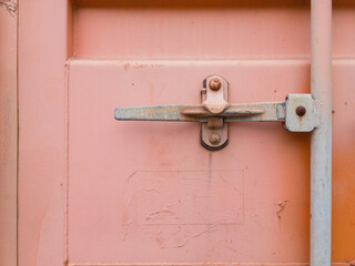 Close-up of a door lock of a red shipping container - 481865771