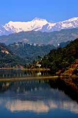 Fototapeta premium Mountain Annapurna and Cage for fish farming in Rupa Lake and the mirror.