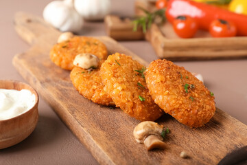 Board with tasty lentil cutlets on table