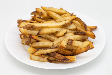Hand Cut French Fries with the Skin on on a White Plate