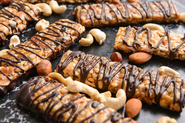 Tasty chocolate nut bars on dark background