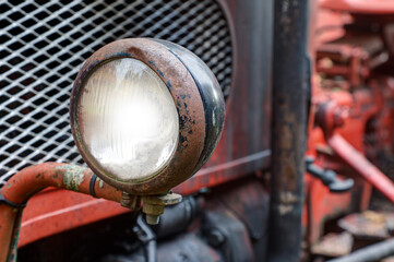Rusted headlights on an old tractor.