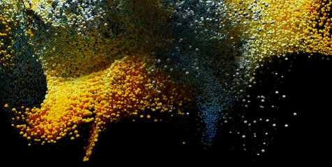 3d render of abstract art with surreal explosion powder foam cloud based on small balls spheres or bubbles particles in yellow blue and white color in plastic and metal material on isolated black back