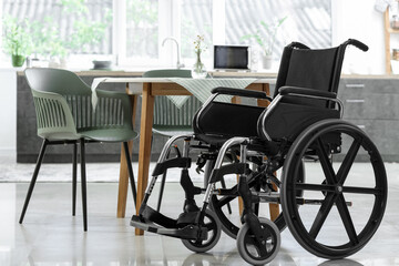 Empty wheelchair in modern kitchen