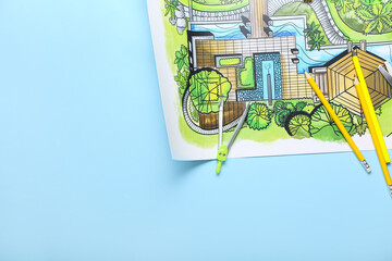 Landscape designer's plan with stationery on blue background