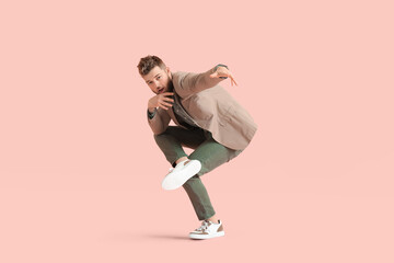 Cool dancing young man on color background