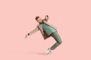 Fototapeta na wymiar Cool dancing young man on color background