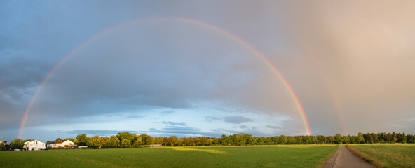 rainbow over the fields, on the outskirts of hohenkirchen village, panorama landscape