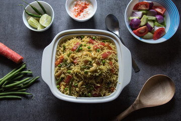 Homemade Indian lunch item pulao or vegetable fried rice or biryani served in a bowl. 